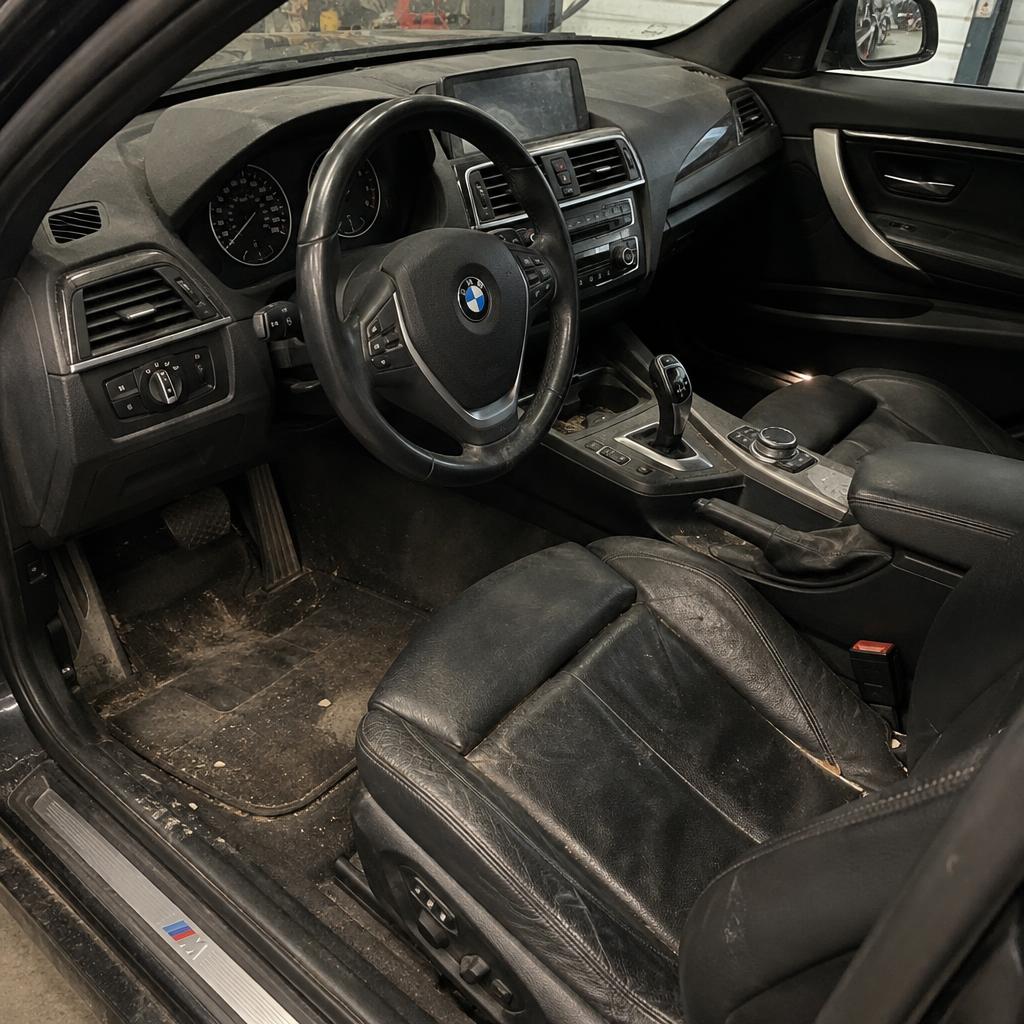 Dusty, stained car interior before detailing